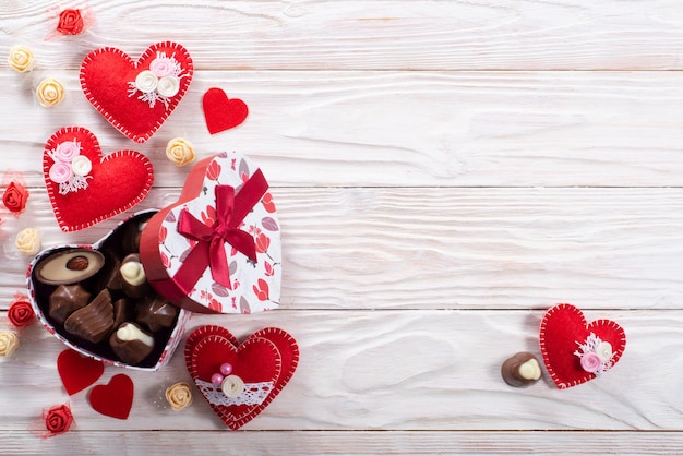 Chokolate box in shape of heart on white wooden table valentine background with copy space