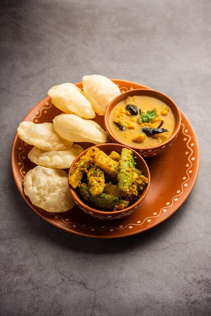 Photo cholar dal and patol aloo sabzi served with fried luchi or poori bengali food