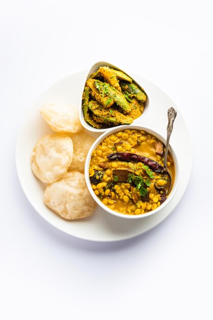 Cholar dal and patol aloo sabzi served with fried Luchi or poori bengali food