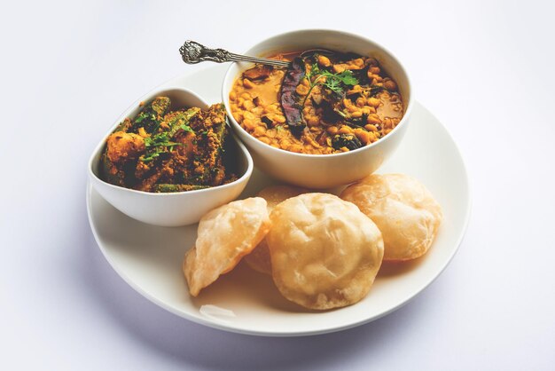 Cholar dal and patol aloo sabzi served with fried Luchi or poori bengali food