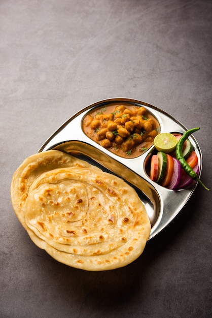 Chole or Chana Masala with Paratha, Chickpea spicy curry served with laccha parantha. Popular North Indian Dish