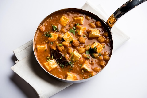 Chole Paneer curry gemaakt van gekookte kikkererwten met kwark met kruiden. Populair Noord-Indiaas recept. geserveerd in een kom of serveerschaal. Selectieve focus