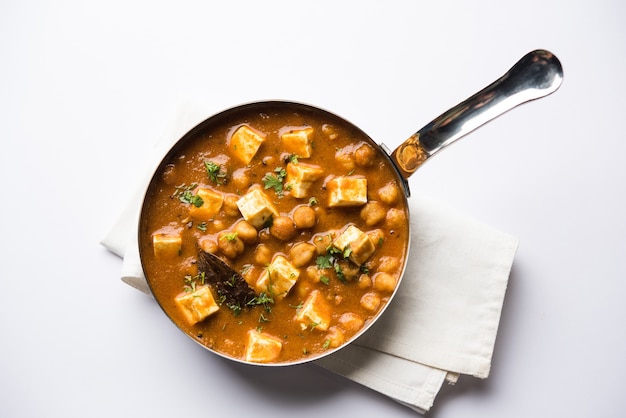 Chole Paneer curry made using boiled chickpea with cottage cheese with spices. Popular North Indian recipe. served in a bowl or serving pan. Selective focus