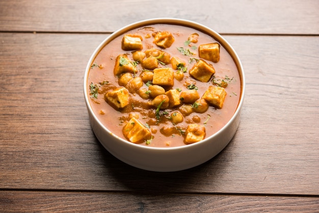 Chole Paneer curry made using boiled chickpea with cottage cheese with spices. Popular North Indian recipe. served in a bowl or serving pan. Selective focus