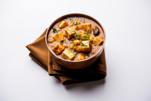 Chole Paneer curry made using boiled chickpea with cottage cheese with spices. Popular North Indian recipe. served in a bowl or serving pan. Selective focus