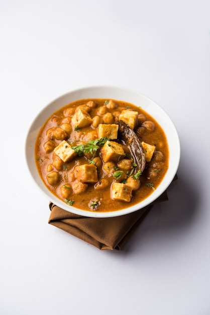 Chole Paneer curry made using boiled chickpea with cottage cheese with spices. Popular North Indian recipe. served in a bowl or serving pan. Selective focus