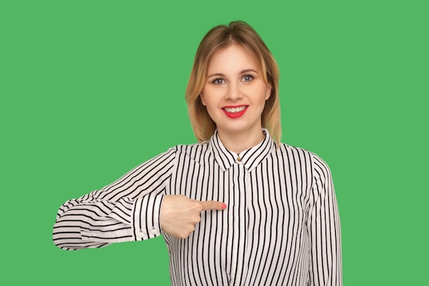 Choose me I39m winner Gorgeous blond girl with red lips pointing herself and smiling excitedly to camera being proud and confident in her beauty indoor studio shot isolated on green background