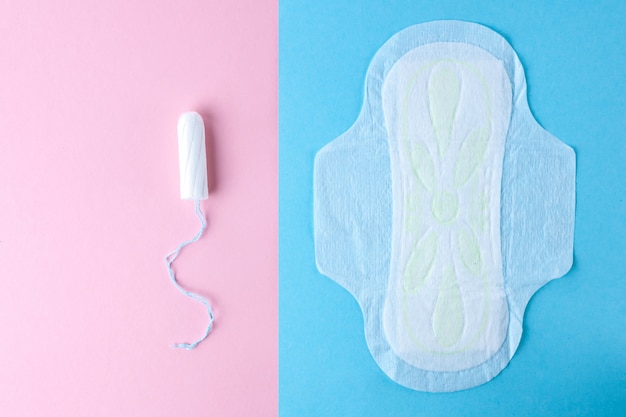 Choose between tampon and feminine sanitary pads for critical days. Hygiene care during critical days. Menstrual cycle. Women's and gynecological health care. Hygiene, monthly protection