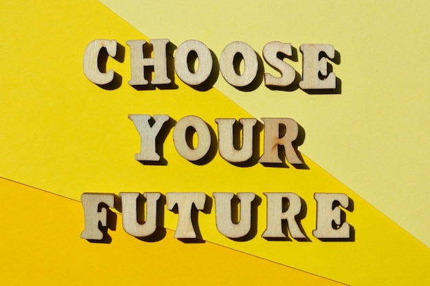 Choose Your Future words in wooden alphabet letters isolated on bright yellow background