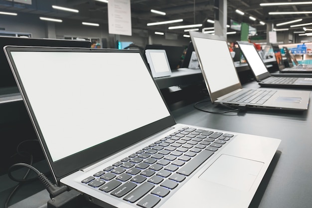 Choosing and buying a laptop in the computer department store.