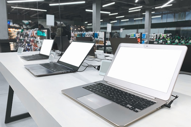 Photo choosing and buying a laptop in the electronics store. computer shop.