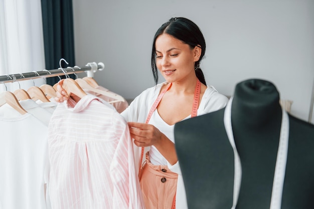 Choosing clothes Seamstress is in her office