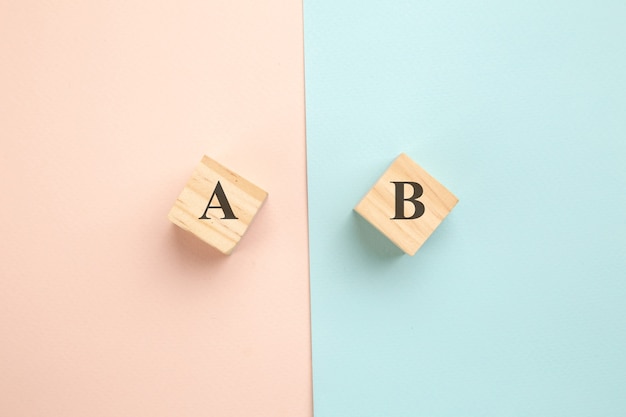 Photo choosing concept. a or b on wood blogs on colorful background.