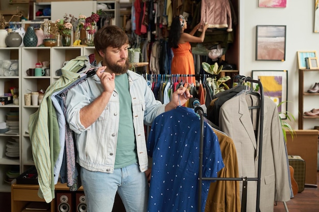 choosing stylish shirt in thrift shop