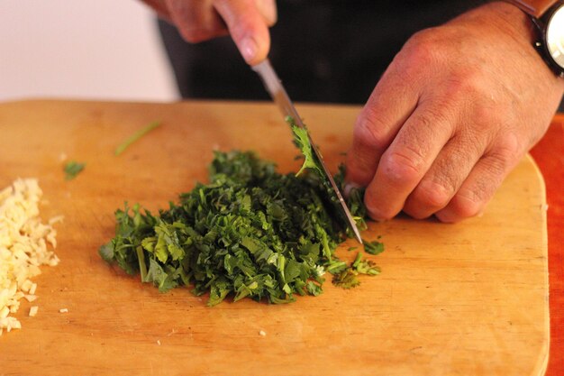 Chop coriander on a wooden board