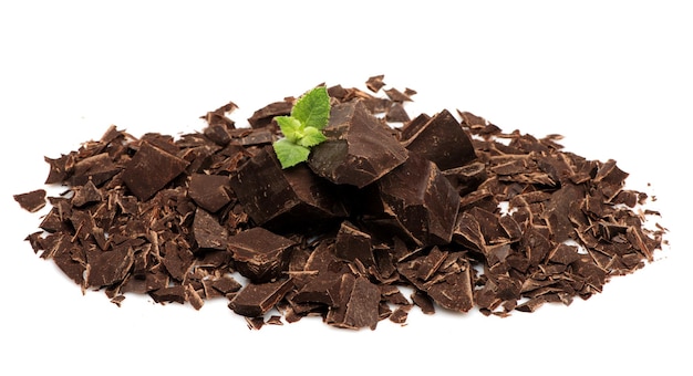 Chopped black chocolate and fresh mint on a white background