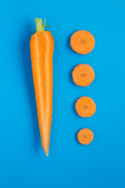 Chopped carrot on the blue table. Top view.Flat lay.