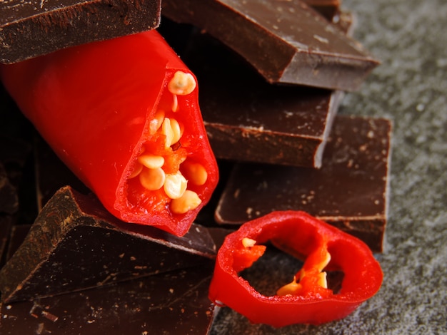 Chopped chocolate with chili pepper. Macro.