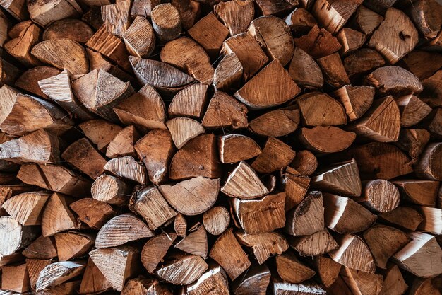 Chopped firewood is stacked in a big pile