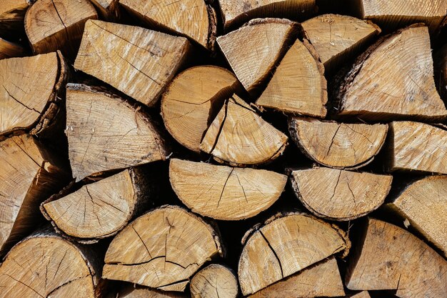 Chopped firewood is stacked in a big pile