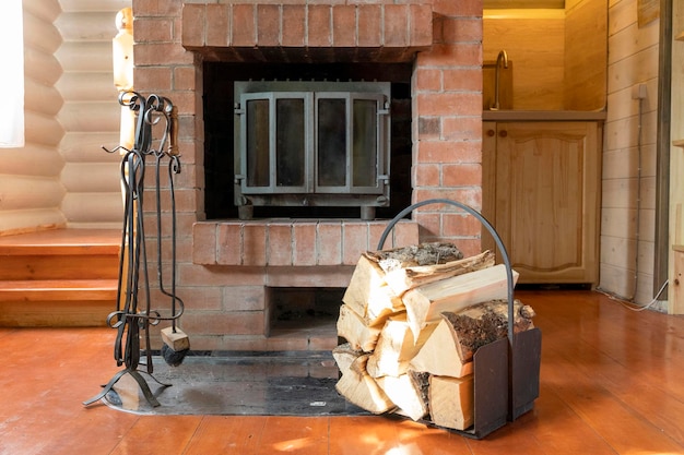 Photo chopped firewood stacked in woodpile against background of fireplace