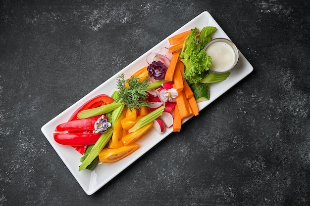 Chopped fresh vegetables with sauce on a plate