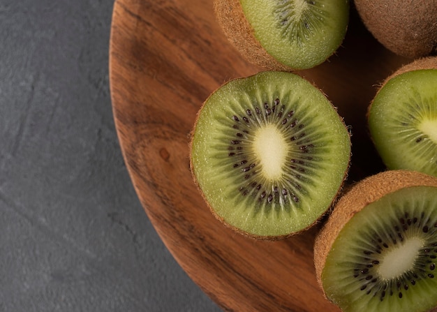 chopped kiwi on a wooden plate