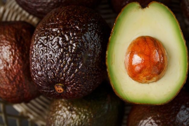 Chopped pitted and whole organic Hass avocado close-up