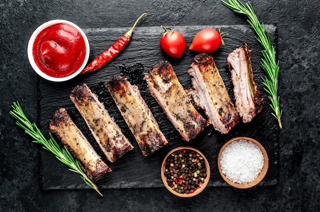 chopped pork ribs on the grill on a stone background