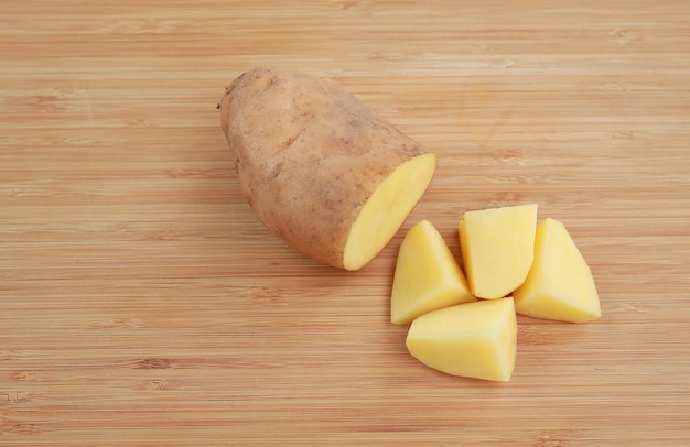 Chopped potatoes on wood board.