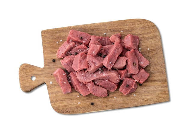 Chopped topside meat over wooden board with seasonings isolated over white background