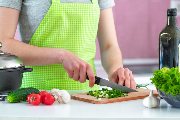 Chopped vegetables for fresh salad on cutting board for dinner close up