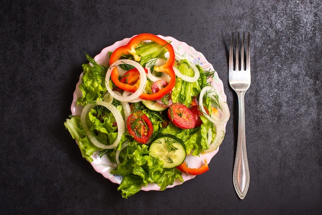 Chopped vegetables mixed on a plate with.a fork