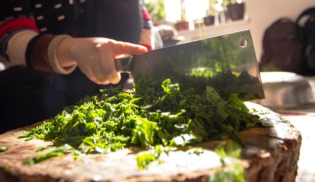 Premium Photo | Chopping spinach leaves for salad