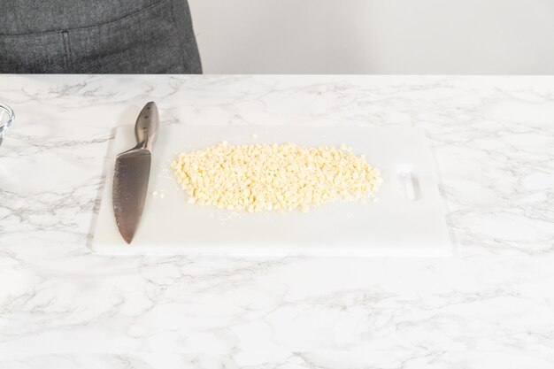 Chopping white chocolate chips for irresistible baking creations