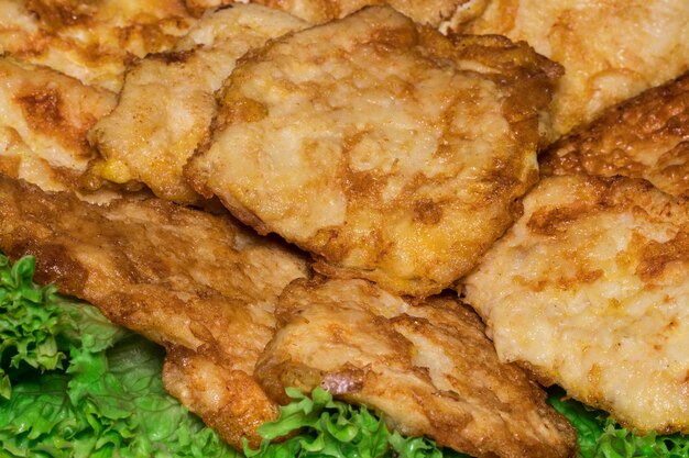 Chops, on a platter with lettuce leaves. Close up.