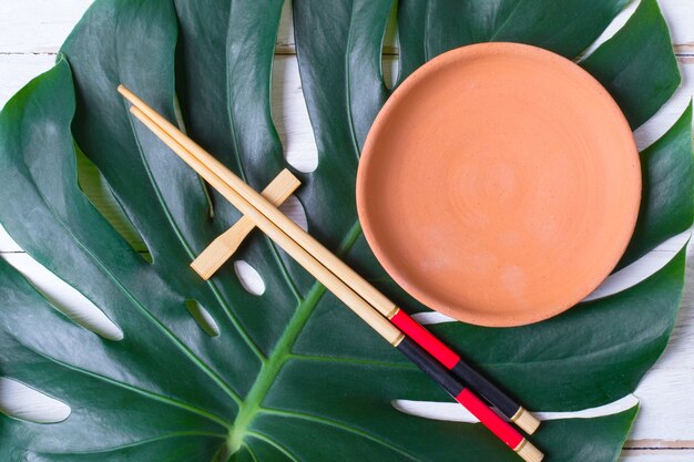 Chopstick and ceramic handmade dish. Asian food concept.