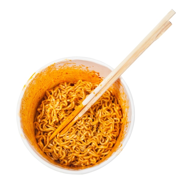 Chopsticks in cup with spicy instant noodles