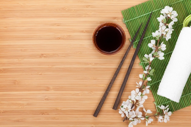 Chopsticks sakura branch soy sauce and bamboo mat