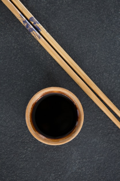 Chopsticks and soy sauce on stone table