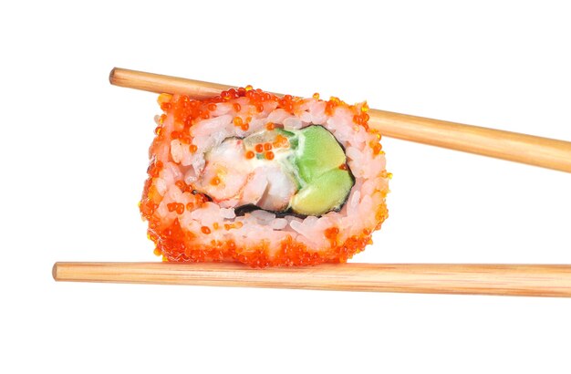 Chopsticks with tasty sushi roll on white