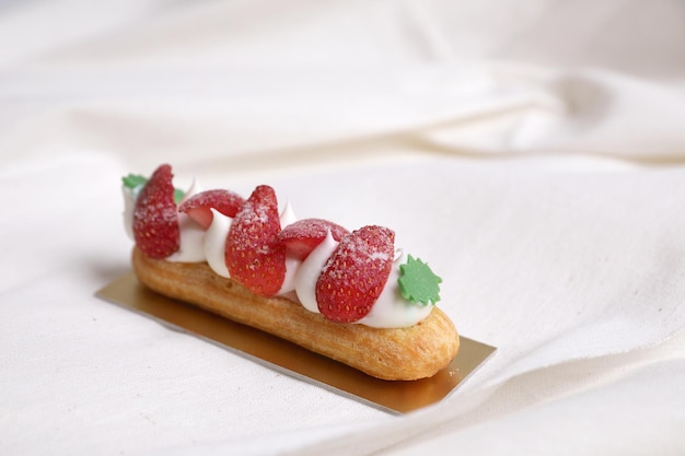 Choux cream with strawberry isolated in white background