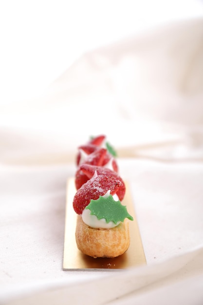 Choux cream with strawberry isolated in white background