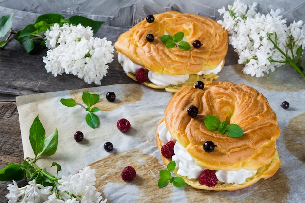 choux pastry cake Paris Brest, raspberries, almond, sugar powder and mint. eclair. 