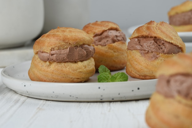 choux pastry or  Cream puffs filled chocolate custardwhite background