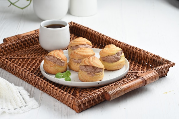 choux pastry or  Cream puffs filled chocolate custardwhite background