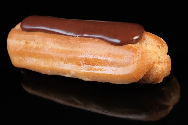 Choux pastry with butter cream with chocolate icing close-up macro 