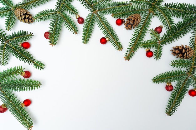 Chrismas holiday decoration with fir branches and pine cones on white background