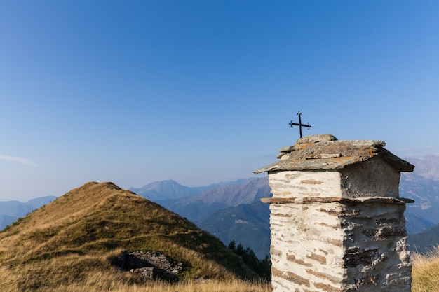 Christian chapel during a sunny day on Italian Alps - faith concept