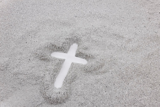 Christian cross drawing in ash as symbol of religion concept